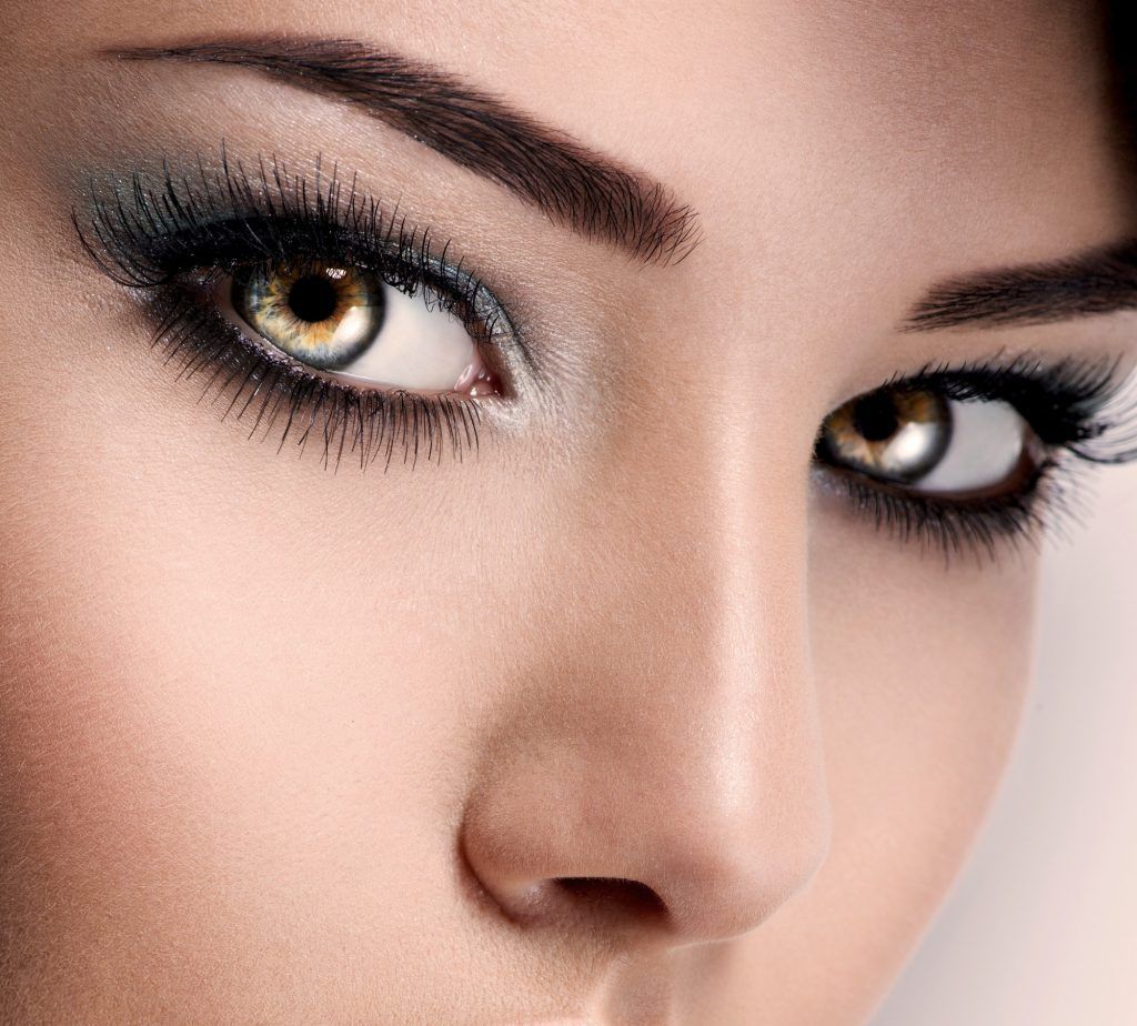 model's face of woman with beautiful blue eyes with long eyelashes