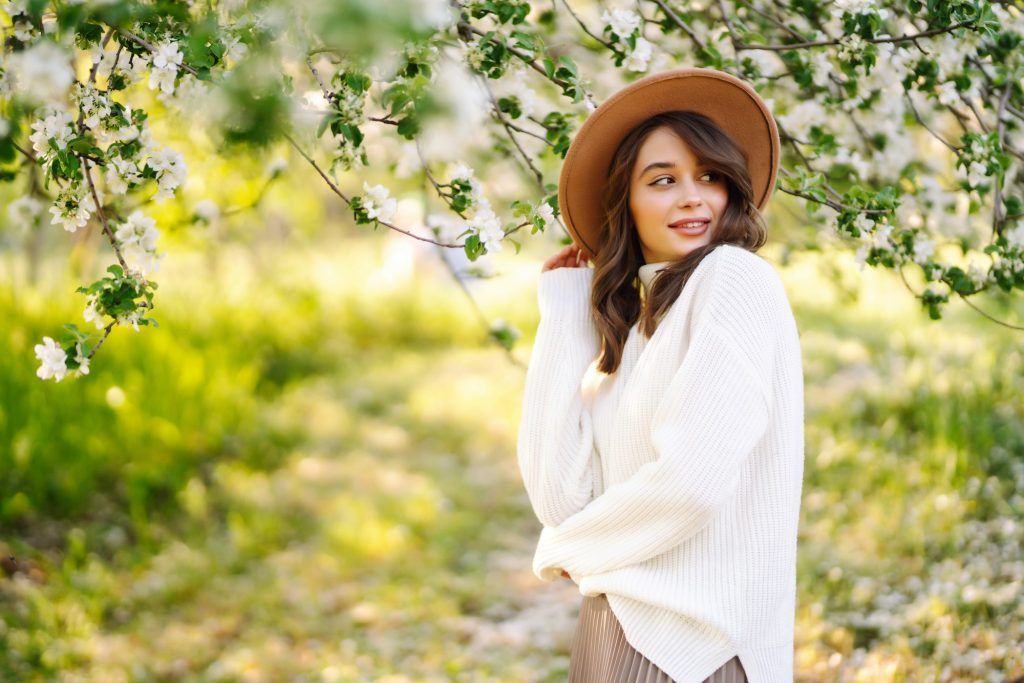 Beautiful young woman near blooming spring tree. Youth, love, fashion, romantic, lifestyle concept.